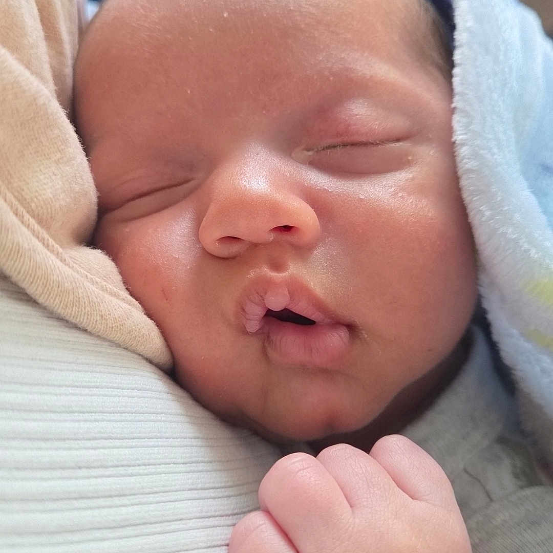 Jayden is registered to the contest to win money with this photo: baby, blanket, child, closeup, comfort, cozy, cute, face, fist, hand, infant, newborn, peaceful, portrait, rest, skin, sleeping, soft, tender, young