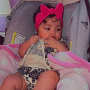 Ciara joined the competition — help win amazing prizes! baby, infant, car_seat, pink_headband, blanket, clothing, child, indoor, person, cute, toddler, seat, headwear, soft, comfort, baby_girl, expression, resting, wrapped, young