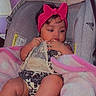 baby, infant, car_seat, pink_headband, blanket, clothing, child, indoor, person, cute, toddler, seat, headwear, soft, comfort, baby_girl, expression, resting, wrapped, young
