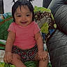 Ciara is registered to the contest to win money with this photo: baby, child, smiling, pink_shirt, shorts, pigtails, blanket, green_blanket, indoor, sofa, leather_sofa, cute, happy, young_child, portrait, seated, cozy, natural_light, home, infant