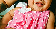 Ciara is registered to the contest to win money with this photo: adult, arm, baby, child, closeup, cute, eyes, face, hair, happy, holding, indoor, infant, person, pink_clothing, polka_dots, portrait, sitting, skin, smiling