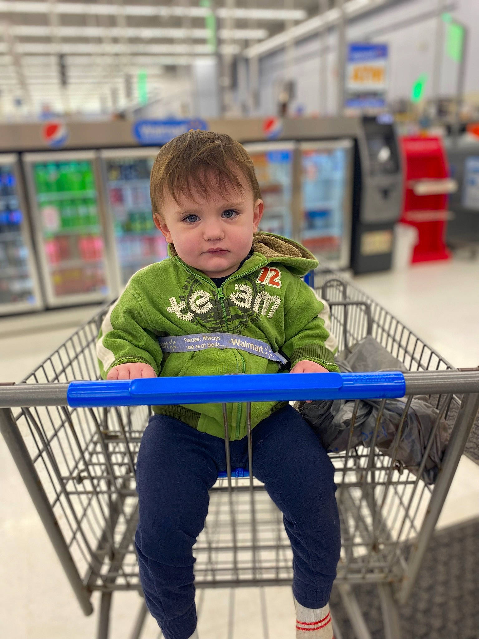 Bennett is registered to the contest to win money with this photo: cart, child, customer, electric_blue, engineering, fun, leisure, person, play, recreation, retail, shelf, shopping_cart, sitting, sleeve, standing, supermarket, t_shirt, tire, toddler