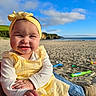 Odie joined the competition — help win amazing prizes! baby, child, smiling, yellow_headband, yellow_dress, beach, sand, toys, blue_sky, clouds, person, legs, boots, sunlight, happy, outdoor, portrait, cute, infant, playtime