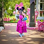 Addilyn joined the competition — help win amazing prizes! child, girl, dress, pink, costume, minnie_mouse, headband, ears, smile, outdoor, daylight, playful, pose, shoes, white_sneakers, bag, park, greenery, decorations, happy