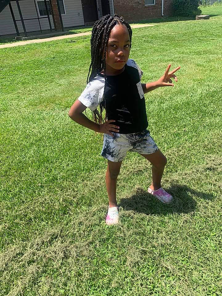 Cam is registered to the contest to win money with this photo: baby_toddler_clothing, foot, fun, grass, grassland, groundcover, happy, human_leg, lawn, leisure, meadow, people_in_nature, person, plant, recreation, shoe, shorts, sneakers, t_shirt, thigh