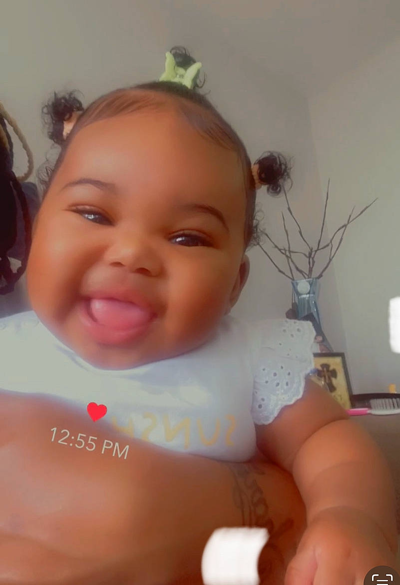 Lariah is registered to the contest to win money with this photo: baby, baby_toddler_clothing, cheek, chest, chin, ear, eyebrow, eyelash, finger, flowerpot, happy, houseplant, iris, lip, neck, nose, person, plant, skin, smile