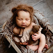 Layla is registered to the contest to win money with this photo: baby, basket, bed, blanket, bodypart, bonnet, chair, face, finger, furniture, hand, happy, head, newborn, person, photography, portrait, sleeping, smile, toy