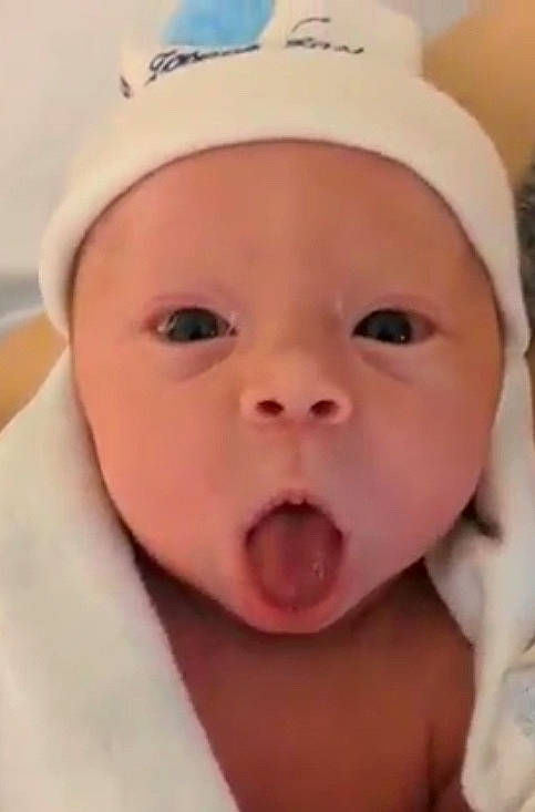 Kayden is registered to the contest to win money with this photo: baby, cap, cheek, child, close_up, eyebrow, eyelash, fashion_accessory, fun, happy, headwear, lip, mouth, nose, person, portrait_photography, skin, smile, surprise, thumb