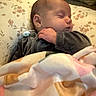 Sutton is registered to the contest to win money with this photo: baby, sleeping, blanket, pillow, pacifier, infant, child, cozy, rest, peaceful, soft, indoor, cute, face, hand, clothing, portrait, young, comfort, nap