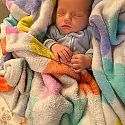 Sutton joined the competition — help win amazing prizes! newborn, baby, sleeping, blanket, colorful, soft, pastel, hands, cozy, cute, infant, wrapped, resting, peaceful, portrait, child, fabric, warm, indoor, comfort