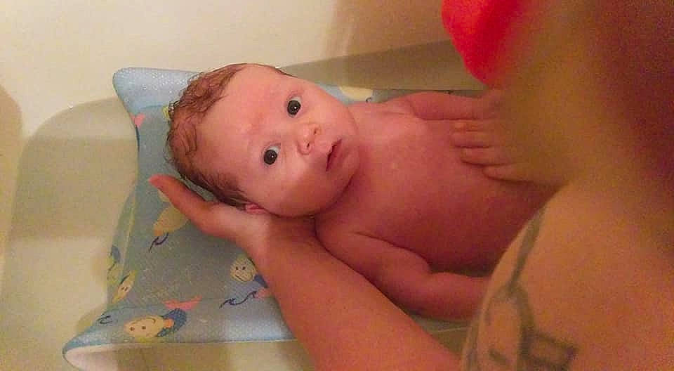 Tucker is registered to the contest to win money with this photo: baby, bathing, bedtime, cheek, child, ear, eye, face, finger, hand, head, mouth, neck, nose, person, skin, thumb, toddler
