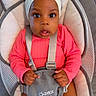 Leilany is registered to the contest to win money with this photo: baby, infant, headband, flower, pink_clothing, baby_seat, straps, cushion, wide_eyes, curious, child, indoors, cute, portrait, person, seat, comfortable, small_hands, looking, expression