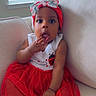 baby, bow, child, couch, cozy, curious, cute, fingers_in_mouth, girl, headband, home, indoor, infant, person, portrait, red_dress, sitting, soft_light, white_furniture, window