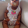 Leilany joined the competition — help win amazing prizes! baby, bow, child, clothing, colorful, couch, cute, expression, face, feet, furniture, hands, headband, indoors, infant, legs, pacifier, relaxed, sitting, skin