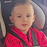 child, toddler, car_seat, red_hoodie, spider_man, seatbelt, car_interior, safety, young_child, boy, casual_clothing, portrait, cute, vehicle, seat, child_safety, young_face, indoors, car_window, child_in_car