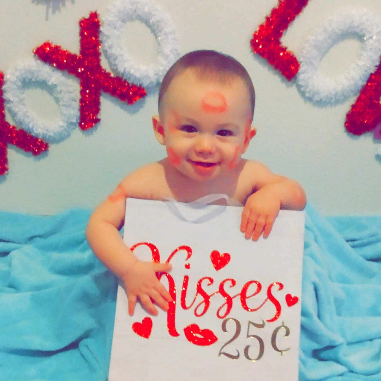 Thomas joined the competition — help win amazing prizes! baby, child, face, smile, kiss_mark, sign, text, xoxo, love, red, white, blue_blanket, indoor, cute, happy, sitting, decoration, holiday, playful, portrait