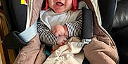 Jonah Mercier a rejoint le concours — aidez-le/la à gagner de superbes lots ! baby, infant, car_seat, red_hat, knit_hat, smiling, blanket, striped_sleeves, socks, penguin_socks, buckle, hood, cozy, cute, cheeks, portrait, indoor, toy, seatbelt, happy