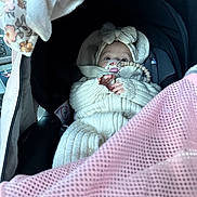 Asila joined the competition — help win amazing prizes! baby, infant, car_seat, knitted_clothing, pacifier, beaded_clip, headband, bow, pink_mesh, cozy, warm_clothing, child, cute, wrapped, seatbelt, car_interior, portrait, small_hands, face, eyes
