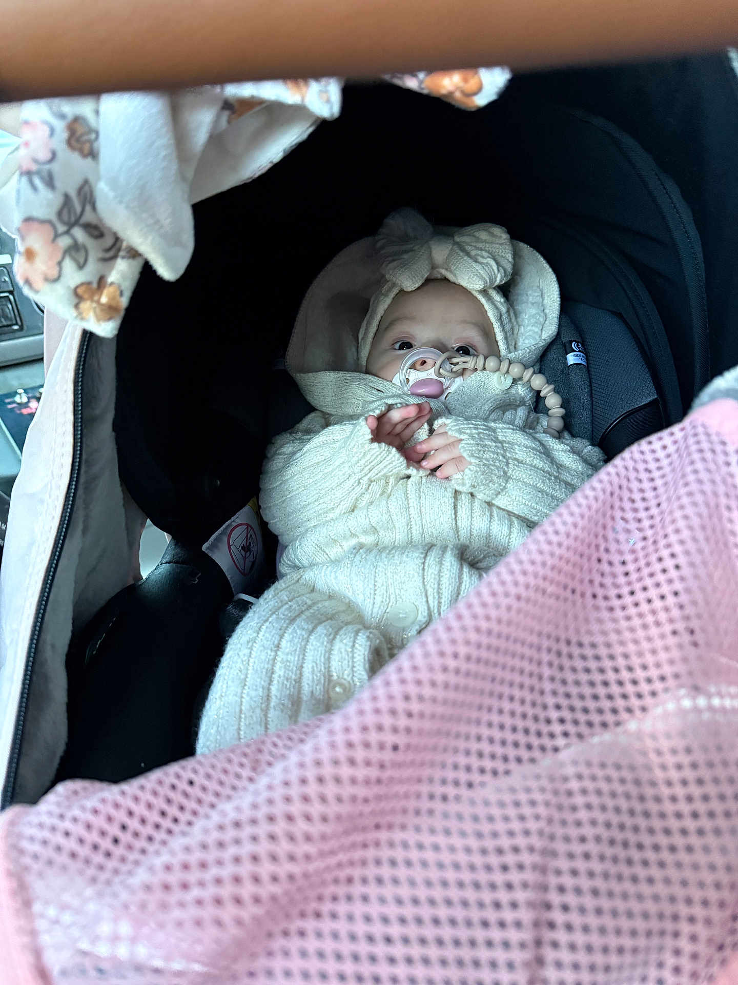 Asila joined the competition — help win amazing prizes! baby, infant, car_seat, knitted_clothing, pacifier, beaded_clip, headband, bow, pink_mesh, cozy, warm_clothing, child, cute, wrapped, seatbelt, car_interior, portrait, small_hands, face, eyes