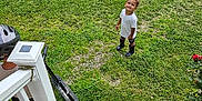 Zehri joined the competition — help win amazing prizes! child, smiling, grass, outdoor, lawn, scooter, helmet, stairs, adult, person, white_tshirt, boots, greenery, daylight, happy, play, nature, recreation, garden, curly_hair