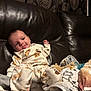baby, infant, pajamas, couch, leather, blanket, pacifier, tongue, playful, indoors, curtain, pattern, cozy, smiling, child, soft, relaxing, furniture, portrait, cute