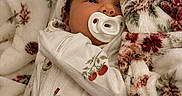 Alannah joined the competition — help win amazing prizes! baby, infant, pacifier, blanket, floral_pattern, sleepwear, cute, cozy, resting, soft, warm, child, face, portrait, newborn, comfort, bed, lying_down, peaceful, young