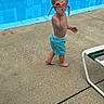 child, boy, pool, goggles, swim_trunks, barefoot, concrete, lounge_chair, water, summer, outdoor, expression, funny, playful, swimming_pool, casual, daytime, young, person, vacation