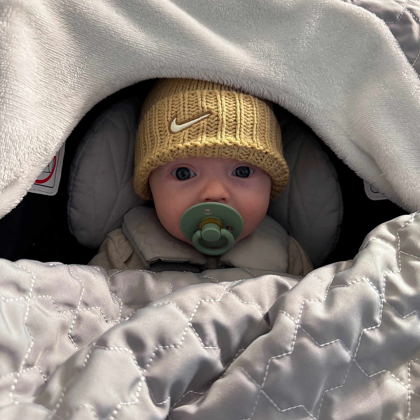 Hudson joined the competition — help win amazing prizes! baby, beanie, bed, blanket, bodypart, bonnet, cap, clothing, face, finger, furniture, hand, hat, head, hood, knitwear, person, photography, portrait, sweater
