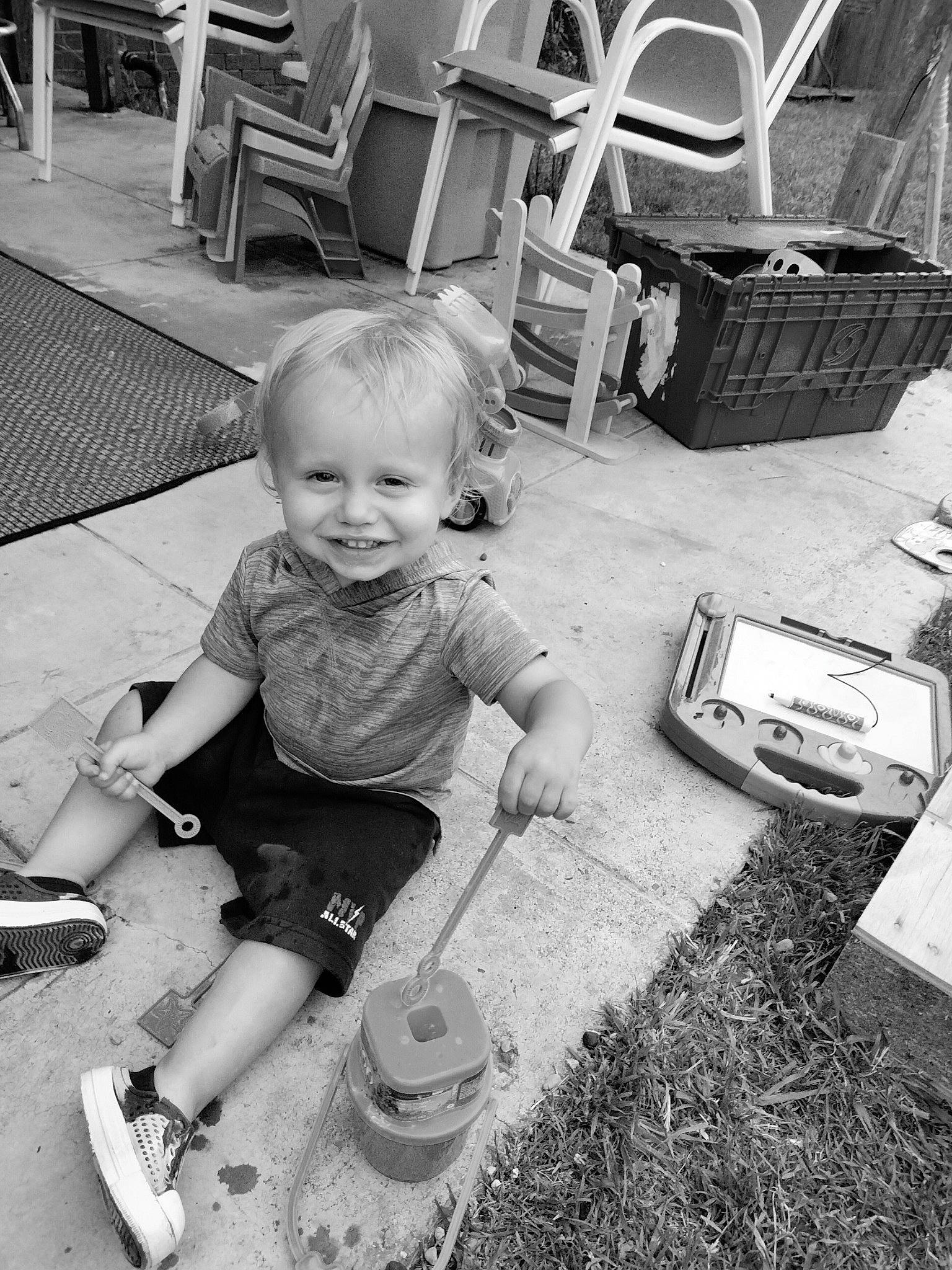 Heath joined the competition — help win amazing prizes! automotive_tire, baby, black, black_and_white, child, fun, grass, happy, joy, monochrome, monochrome_photography, people, person, photograph, shorts, sidewalk, sitting, smile, snapshot, style