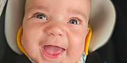 Cassidy is registered to the contest to win money with this photo: baby, bib, blue, car_seat, child, closeup, clothing, cute, face, happy, infant, person, portrait, safety_harness, seat, smiling, straps, white, yellow, young