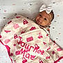 baby, blanket, crib, face, furniture, head, infantbed, person, quilt
