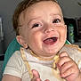 baby, bib, child, clothing, cute, eating, expression, face, food, hand, happy, high_chair, indoor, infant, joy, mouth, person, smiling, snack, toddler