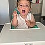 baby, cabinet, child, excited, expression, feeding, floor, furniture, high_chair, home, indoor, kitchen, messy, mouth_open, person, refrigerator, seat, toddler, wet_hair, white_shirt