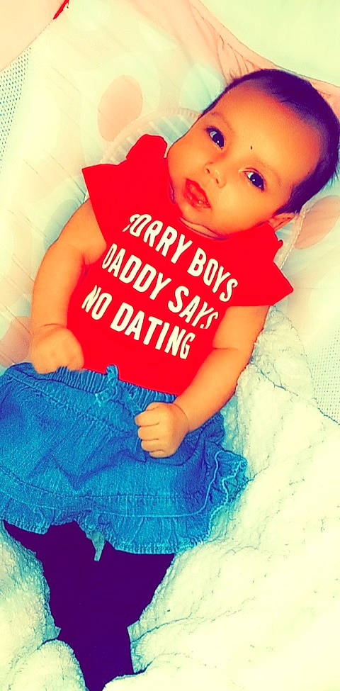 Siennah is registered to the contest to win money with this photo: aqua, arm, baby_toddler_clothing, child, electric_blue, eyelash, finger, font, gesture, hairstyle, happy, mammal, person, pink, product, publication, sleeve, t_shirt, textile, thigh