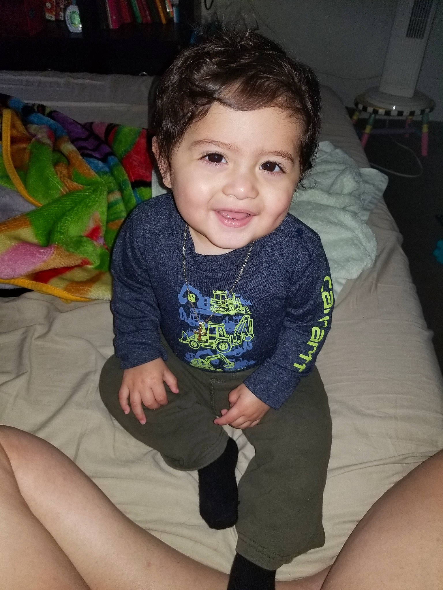 Lionel is registered to the contest to win money with this photo: arm, baby, cheek, child, eye, face, fun, joy, leg, person, sitting, skin, smile, t_shirt, thigh, toddler, vacation