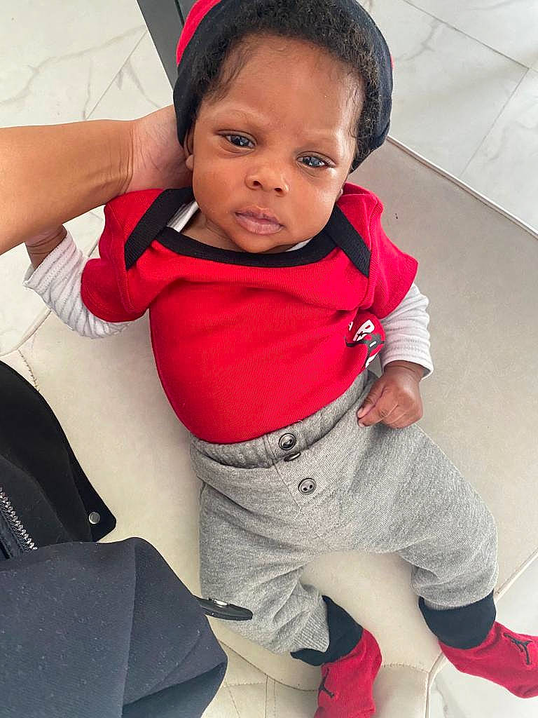 Saïf a rejoint le concours — aidez-le/la à gagner de superbes lots ! baby, baby_toddler_clothing, black_hair, comfort, cool, elbow, eye, face, gesture, happy, joint, knee, leg, neck, person, red, skin, sleeve, thigh, toddler