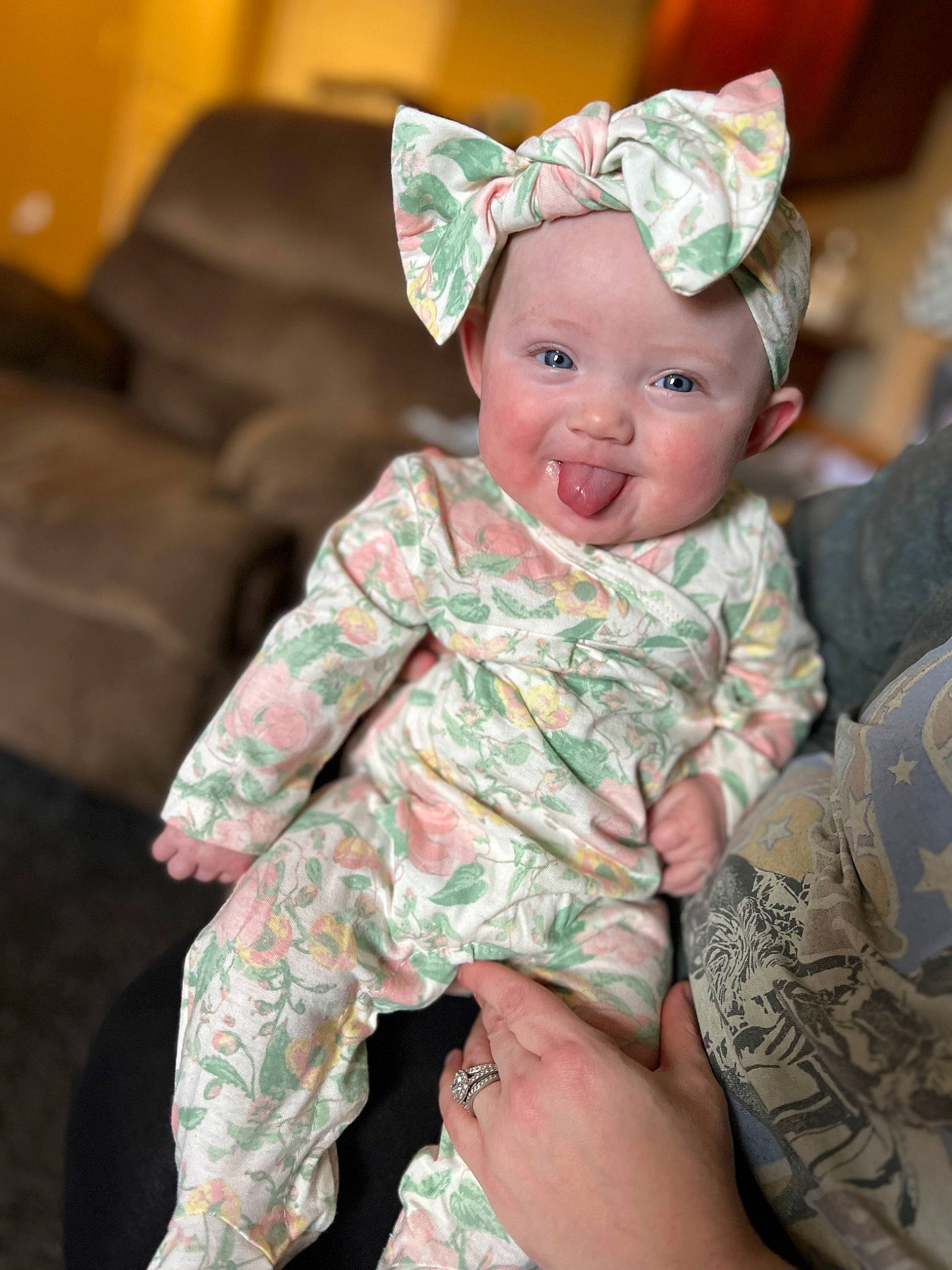 Maci is registered to the contest to win money with this photo: baby, baby_toddler_clothing, cap, child, comfort, costume_hat, couch, facial_expression, happy, head, headgear, headwear, human_body, human_leg, person, pink, sitting, skin, sleeve, smile
