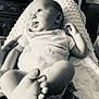 baby, infant, blanket, hand, face, feet, indoors, monochrome, texture, clothing, person, couch, expression, support, newborn, curious, portrait, soft, cozy, relaxing