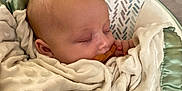 Luna joined the competition — help win amazing prizes! baby, sleeping, blanket, pacifier, infant, cushion, soft_texture, closeup, face, comfort, rest, child, peaceful, indoors, person, head, wrapped, cute, newborn, pattern
