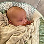 baby, sleeping, blanket, pacifier, infant, cushion, soft_texture, closeup, face, comfort, rest, child, peaceful, indoors, person, head, wrapped, cute, newborn, pattern