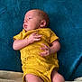 Luna is registered to the contest to win money with this photo: baby, infant, yellow_onesie, giraffe_print, blue_blanket, blanket, lying_down, cozy, soft, newborn, cute, small_hands, small_feet, sleepwear, indoors, child, resting, portrait, skin, person