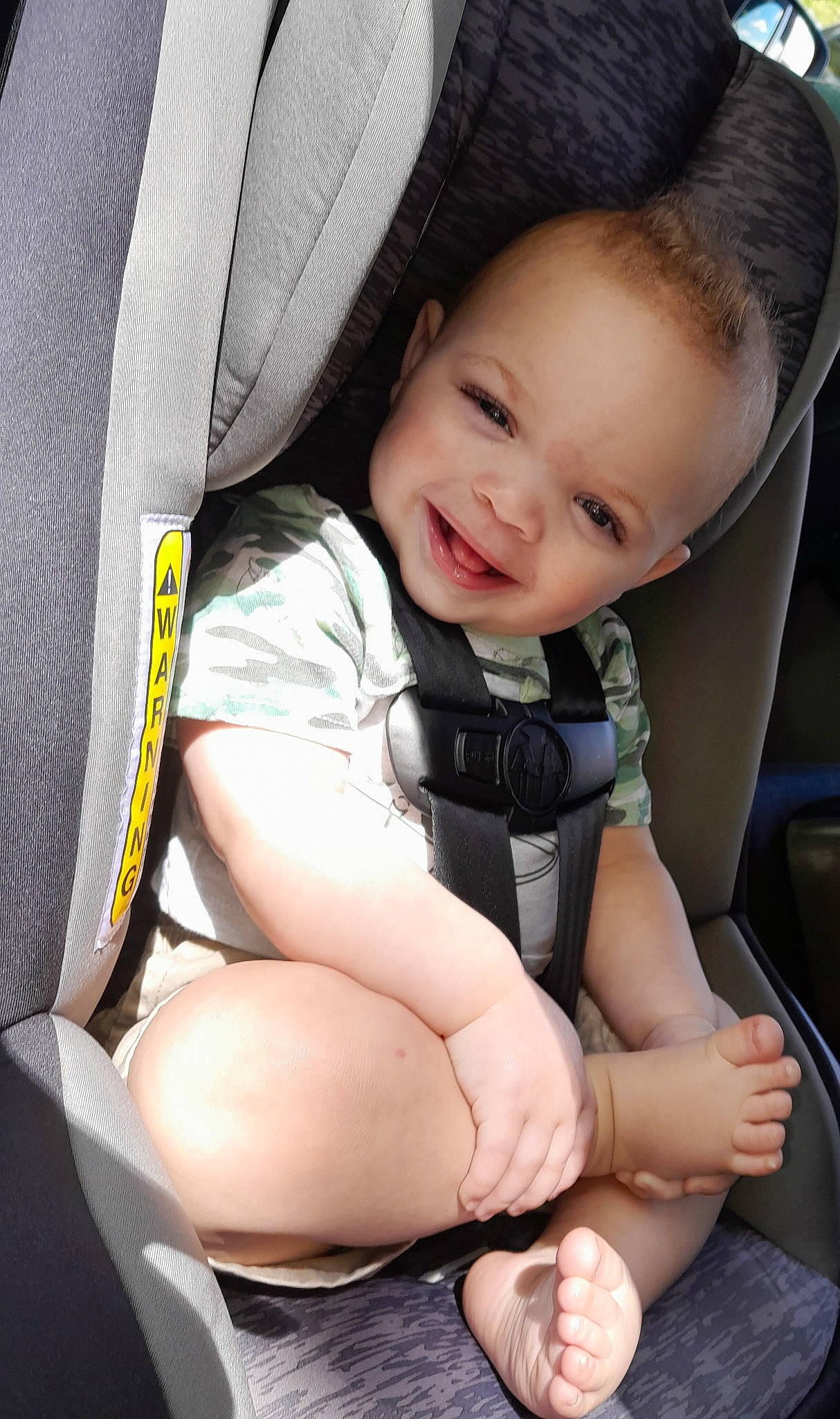 Kingston is registered to the contest to win money with this photo: auto_part, automotive_design, baby, baby_in_car_seat, baby_toddler_clothing, car_seat, car_seat_cover, child, comfort, finger, gesture, happy, joy, leg, person, seat_belt, skin, smile, steering_wheel, thigh