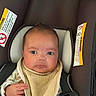 Jackson is registered to the contest to win money with this photo: alert, baby, bib, blanket, brown_hair, car_seat, child, clothing, eyes, face, hands, head, indoors, infant, looking_at_camera, photography, portrait, safety_harness, sitting, vehicle