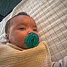 Jackson joined the competition — help win amazing prizes! baby, infant, child, pacifier, blanket, swaddled, portrait, close_up, face, eyes, indoor, bed, bedding, cozy, sleeping_area, baby_clothing, soft_lighting, head, calm, photography