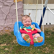 Cheyanne is registered to the contest to win money with this photo: toddler, child, swing, outdoor, grass, playground, smiling, happy, pigtails, plastic_swing, footwear, greenery, window, wooden_wall, rustic, playtime, fun, baby, person, casual_clothing