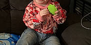 Cheyanne is registered to the contest to win money with this photo: toddler, child, smiling, happy, sitting, couch, toy, jeans, socks, sweater, indoor, hair, face, clothing, furniture, person, cute, casual, playful, home