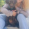 Artemis joined the competition — help win amazing prizes! animal, bench, blue_jeans, casual_clothing, curly_hair, daylight, dog, friendship, happy, leash, mountain, nature, outdoor, pet, plaid_shirt, portrait, sitting, smiling, tree, woman