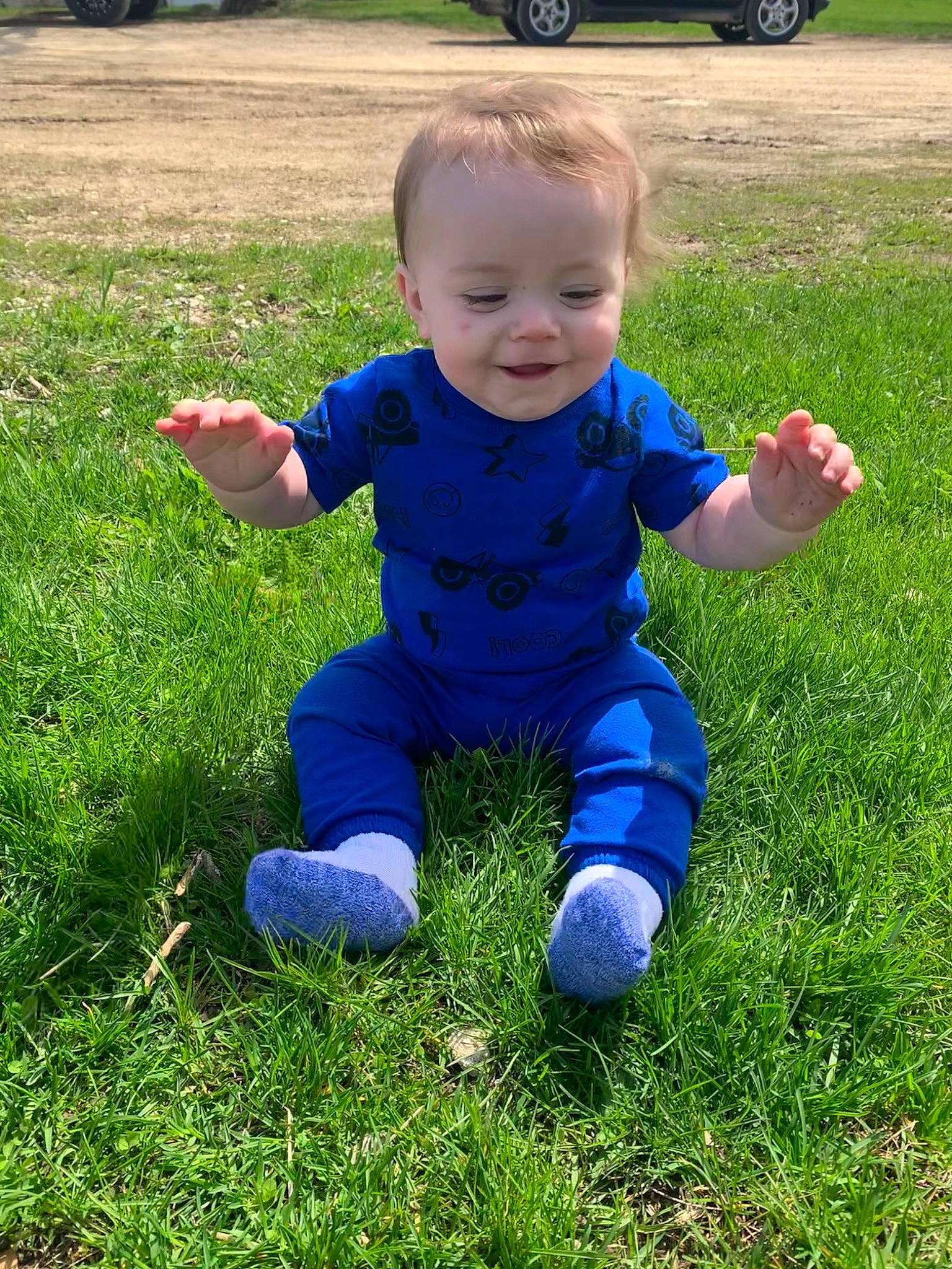 Henry is registered to the contest to win money with this photo: baby, baby_toddler_clothing, ball, child, electric_blue, fun, grass, grass_family, grassland, groundcover, happy, lawn, people_in_nature, person, plant, sitting, smile, sports_equipment, tire, toddler