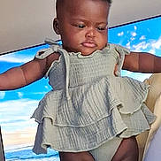 Crystal joined the competition — help win amazing prizes! baby, child, infant, portrait, indoor, television, beach, ocean, dress, outfit, clothing, sitting, being_held, arms_outstretched, serious, face, person, home, photograph, safe