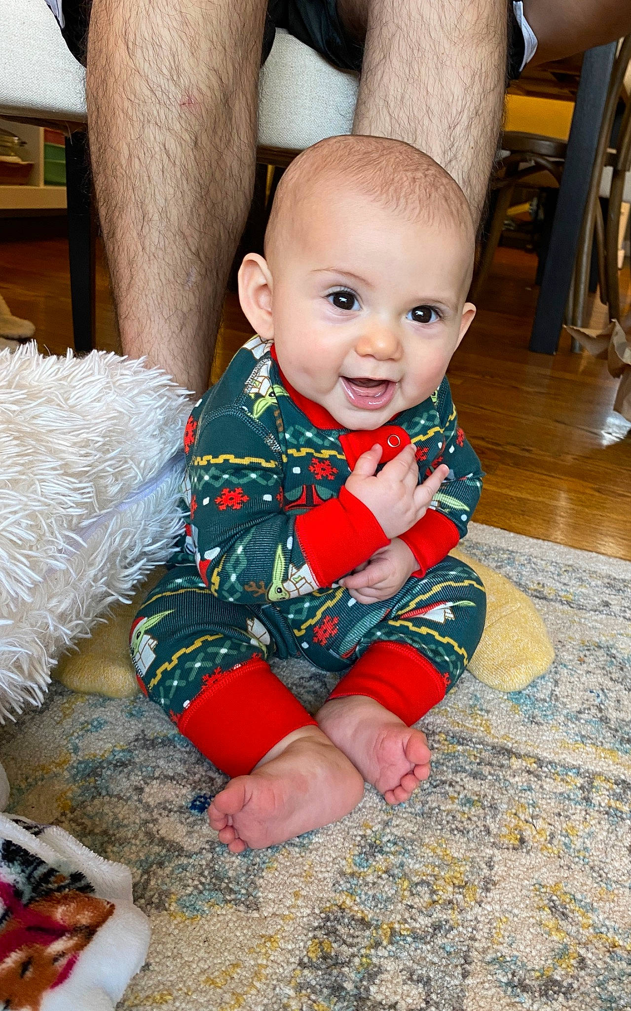 Enrique is registered to the contest to win money with this photo: baby, baby_toddler_clothing, chair, child, comfort, dress, event, fictional_character, flooring, fun, happy, pattern, person, play, red, room, sitting, sleeve, smile, toddler